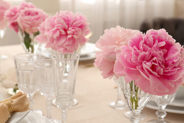 Fototapeta na wymiar Stylish table setting with beautiful peonies indoors. Space for text