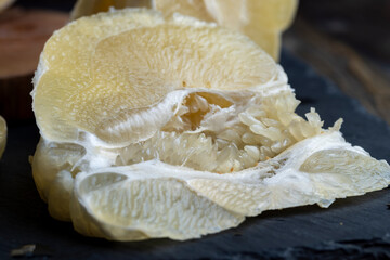 cut into pieces of ripe juicy yellow pomelo