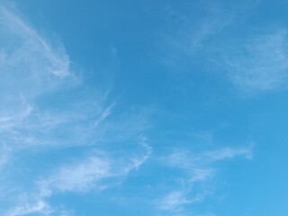 Beautiful white clouds on deep blue sky background. Large bright soft fluffy clouds are cover the entire blue sky. Skyscape on Lombok Island, Indonesia