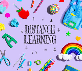 Distance Learning theme with school supplies on a purple background - flat lay