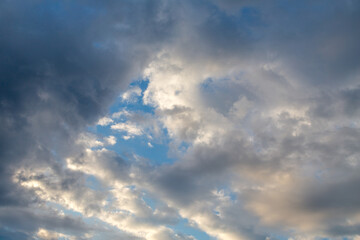 Naklejka na ściany i meble dark clouds with white puffy ones and partly blue sky