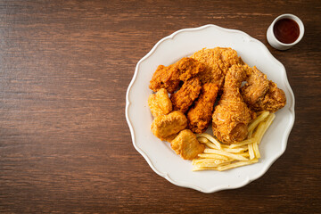 fried chicken with french fries and nuggets on plate