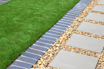 Modern Backyard Design with Artificial Grass, Rocks, and Tiles - 636509896