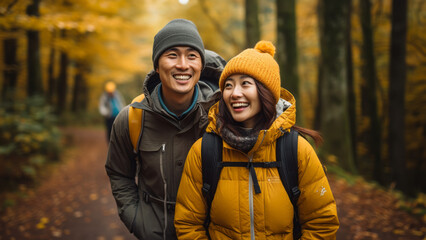 young asian couple hiking in the fall - obrazy, fototapety, plakaty