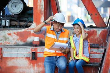 asian engineer with daughter sitting on container cranes © offsuperphoto