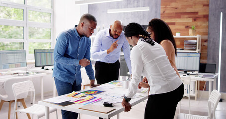 Designer Group At Desk Discussing Custom House