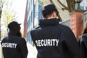 Security Guards Standing Outside Building