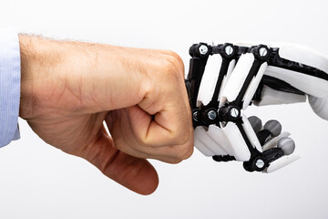 Human Hand And Robot Making Fist Bump