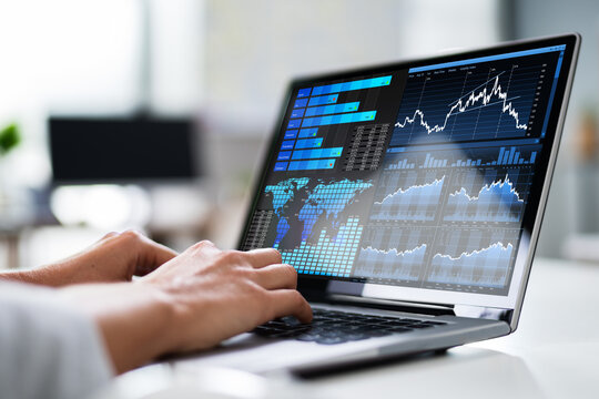 Businesswoman Analyzing Graph On Laptop