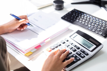 Accountant calculating tax at desk