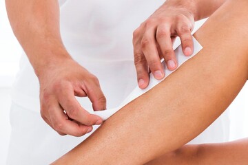 Beautician Waxing Woman's Leg
