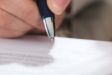 Business Person Signing Document With Pen