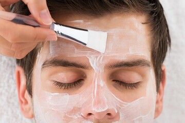 Therapist Applying Face Mask To Man