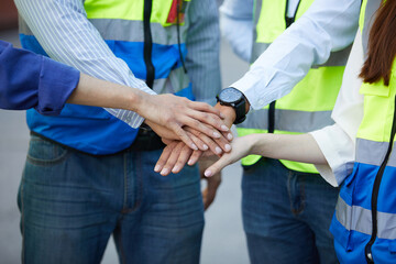 group of workers join hands together for success work or project