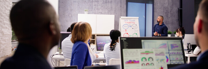 Teacher Showing Presentation To Diverse Group