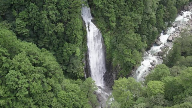 Huge waterfall in the mountains and river in Odaicho, Mie Japan by drone