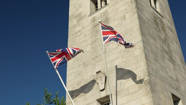 War Memorial Tower with British Flags, in 4K, Slow Motion. Historical Monument in Leek, Staffordshire, England, with Union Jack flag flying.