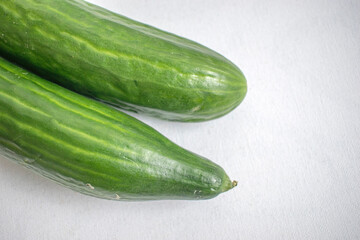 Organic Persian Cucumbers. Presented on a white background.