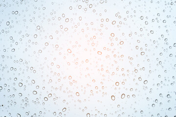blur background with warm light on rainy day, water droplet on mirror