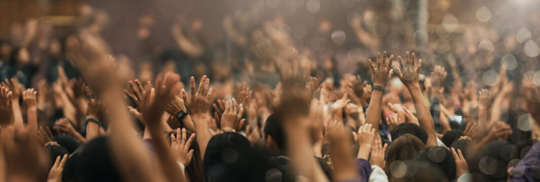 Christian worship with praise to God Ready to raise your hand at the Christian music concert, Holy City. copy space event