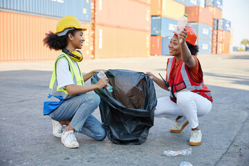 young female African factory workers or engineer picking plastic bottle and garbage bag to clean up in containers warehouse storage