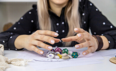 Woman numerologist astrologer counts numbers. Selective focus.