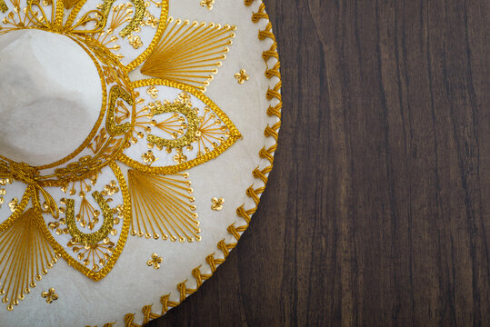 Mexican charro hat on wooden table. Mariachi hat. Typical mexican sombrero.