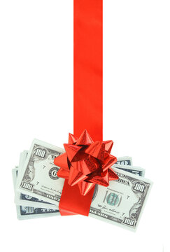 Money gift isolated on white transparent background, PNG. US dollars stack and red bow, festive present.