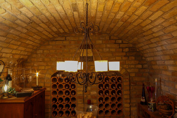 Wine cellar with vaulted ceiling and candle chandelier