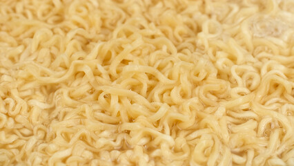 Noodles boiled in boiling hot water on pan