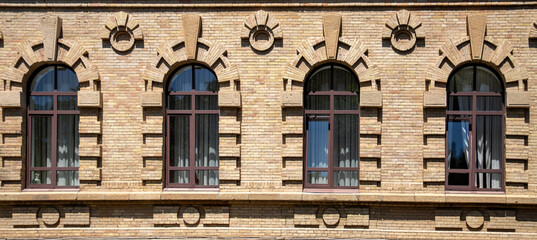 Beautiful architecture of old windows in brick houses.