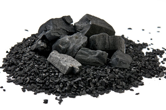 Pile of natural activated carbon scattered isolated on white background. activated carbon is used for effective applications in adsorption, removal of pollutants, water treatment, and energy, etc.