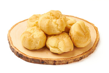 Pile of Cream puffs (Choux cream or Eclair) served on wooden plate isolated on white background. Cream puffs are made with a light choux pastry that puffs up when baked. filled with vanilla cream.