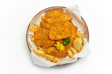 Top view of Fish and Chips (battered fish and fries potato) served in a large bowl decorated with...