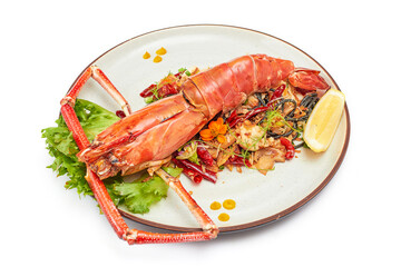 Black pasta stir fried chili with river prawn (Big size) on porcelain plate isolated on white background. The black color of the pasta is caused by the pasta mixed with the black ink of the squid.