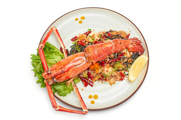 Top view of Black pasta stir fried chili with river prawn (Big size) on plate isolated on white background. The black color of the pasta is caused by the pasta mixed with the black ink of the squid.