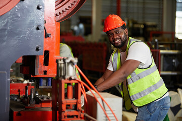 African factory workers or engineer using the machine in the factory