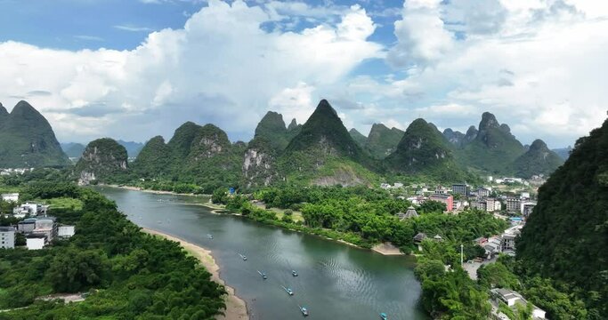 Aerial photography Yangshuo, Guangxi, China, beautiful scenery with blue sky and white clouds, river passing through karst landform