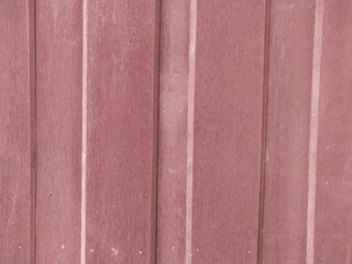 Fototapeta premium The wall is made of beautiful reddish-pink wood.