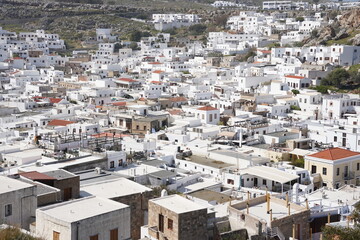 Lindos small whitewashed village and the Acropolis, scenery of Rhodos Island at Aegean Sea.