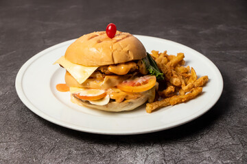 Beef Burger with cheese, mayo and french fries served in dish isolated on background top view of bangladesh food