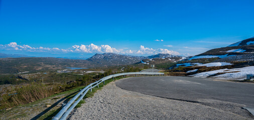 Asphalt road high in the tundra mountains