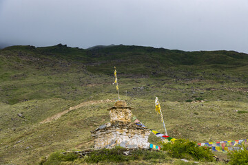 Dark Dramatic Desert Landscape with Foggy Mountains and Distant Houses in Muktinath, Mustang, Nepal