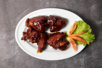 Chicken Hot Wings served in dish isolated on background top view of bangladesh food
