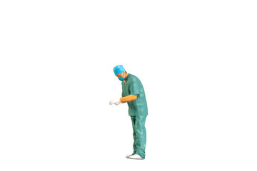 Miniature people young doctor in scrubs Isolated on white background with clipping path