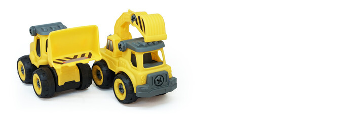 Fototapeta premium yellow plastic truck and bulldozer toy isolated on white background with copy space for text or banner