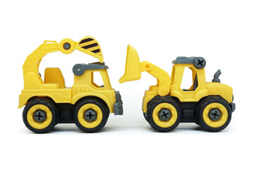 yellow plastic truck and bulldozer toy facing each other isolated on white background. heavy construction vehicle.