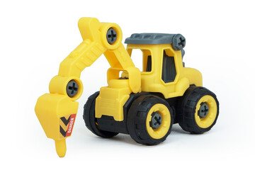 yellow plastic tractor drill toy isolated on white background. heavy construction vehicle.
