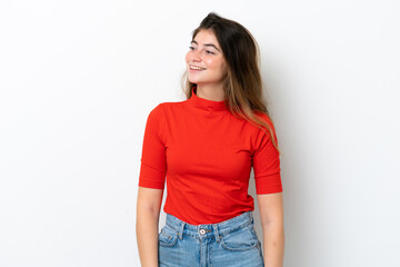 Young caucasian woman isolated on white background looking to the side and smiling