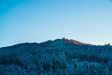 Germany, Sunrise light on beautiful black forest schwarzwald mountains snow covered cold winter...